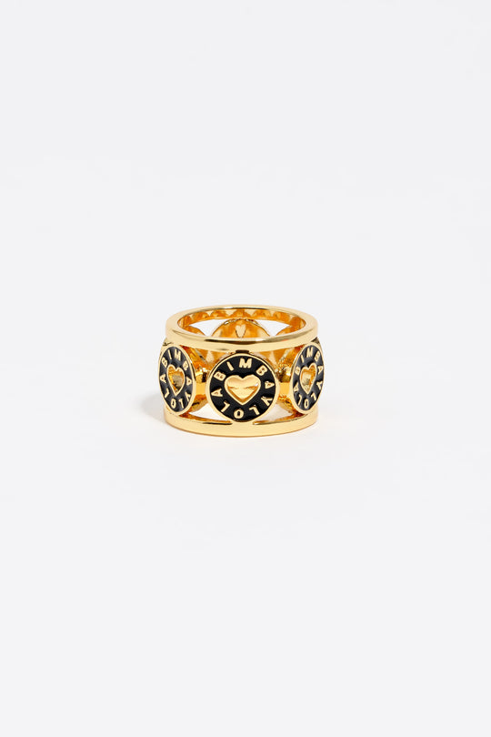 Gold-tone metal ring with black heart logo
