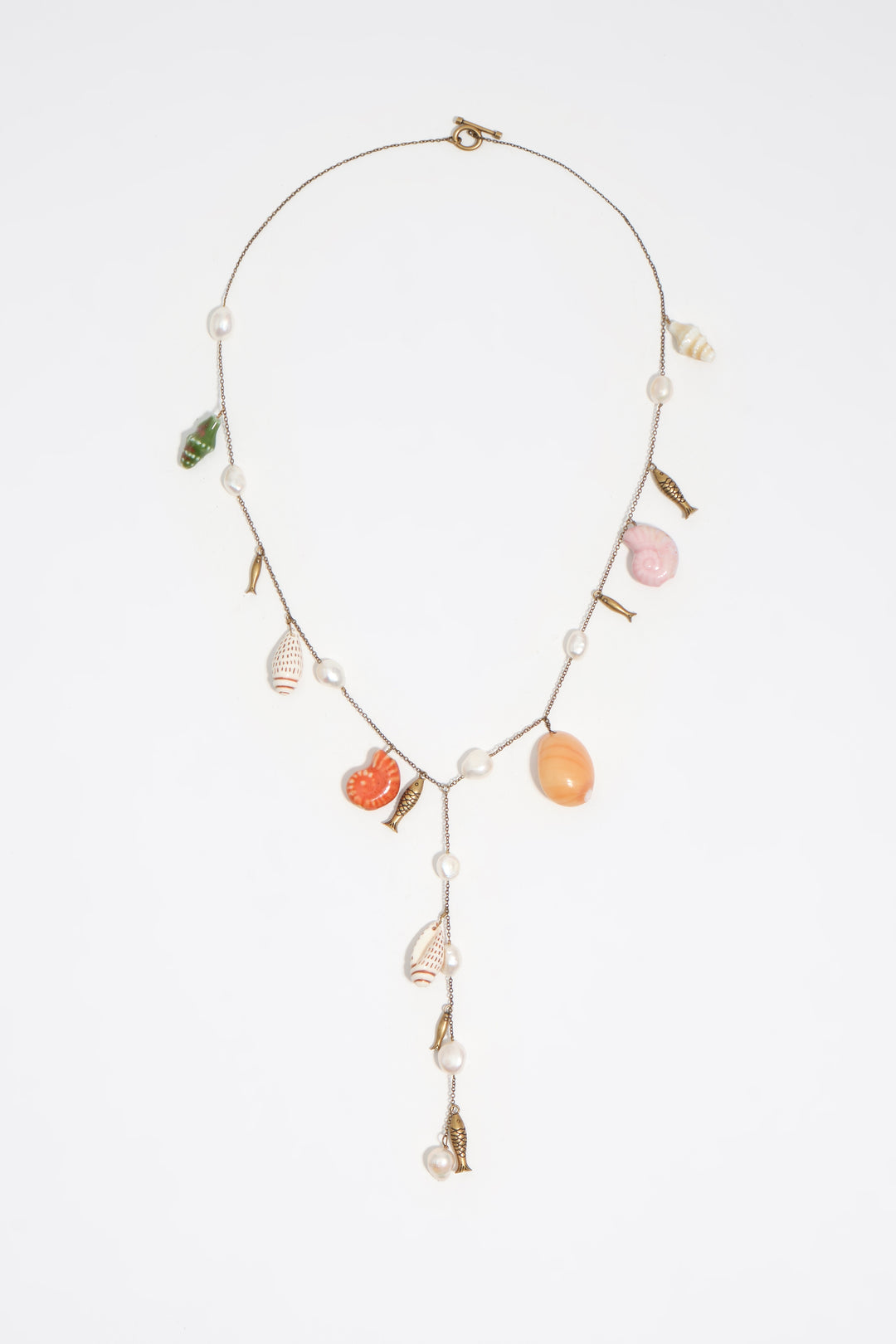 Aged gold necklace with ceramic fish and shells