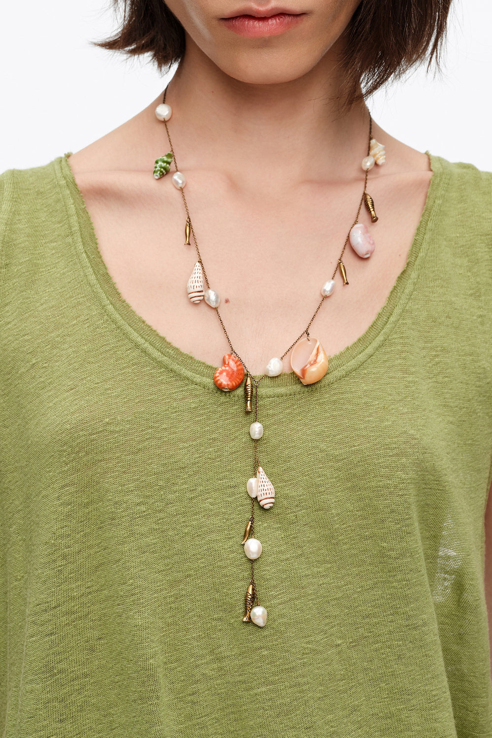 Aged gold necklace with ceramic fish and shells