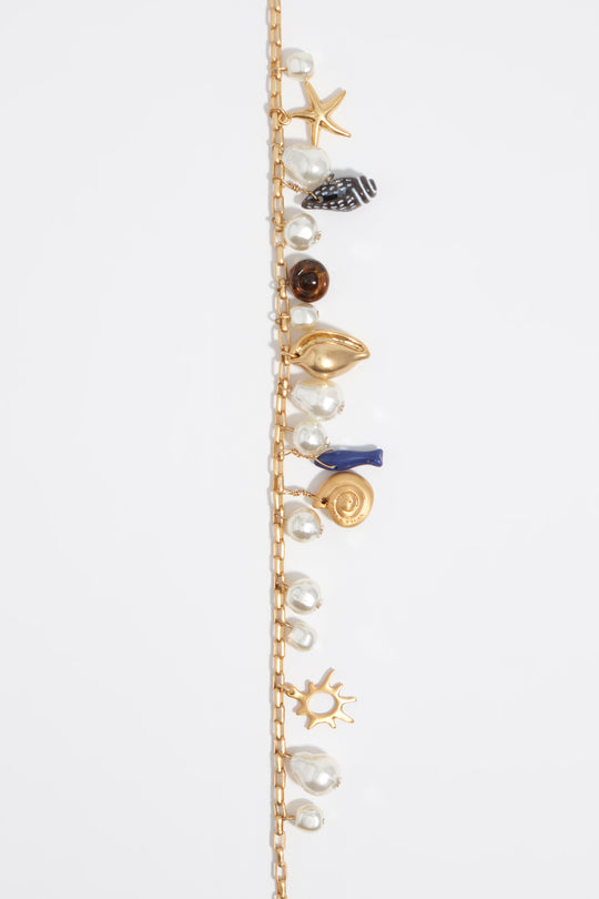 Aged gold necklace with shells and fish