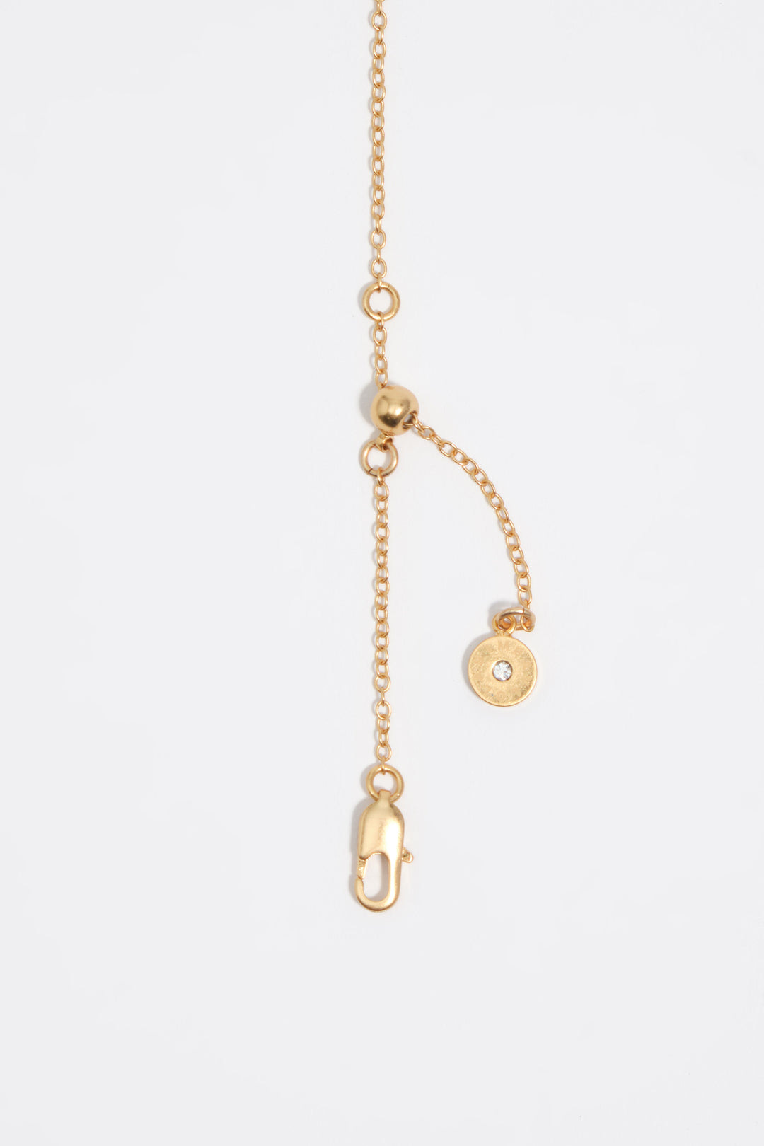 Aged gold necklace with fish and stone