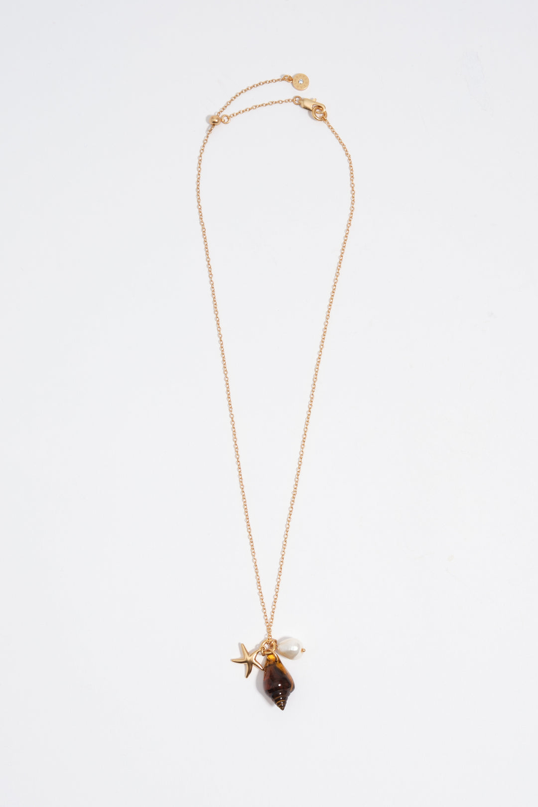 Aged gold star and shell necklace