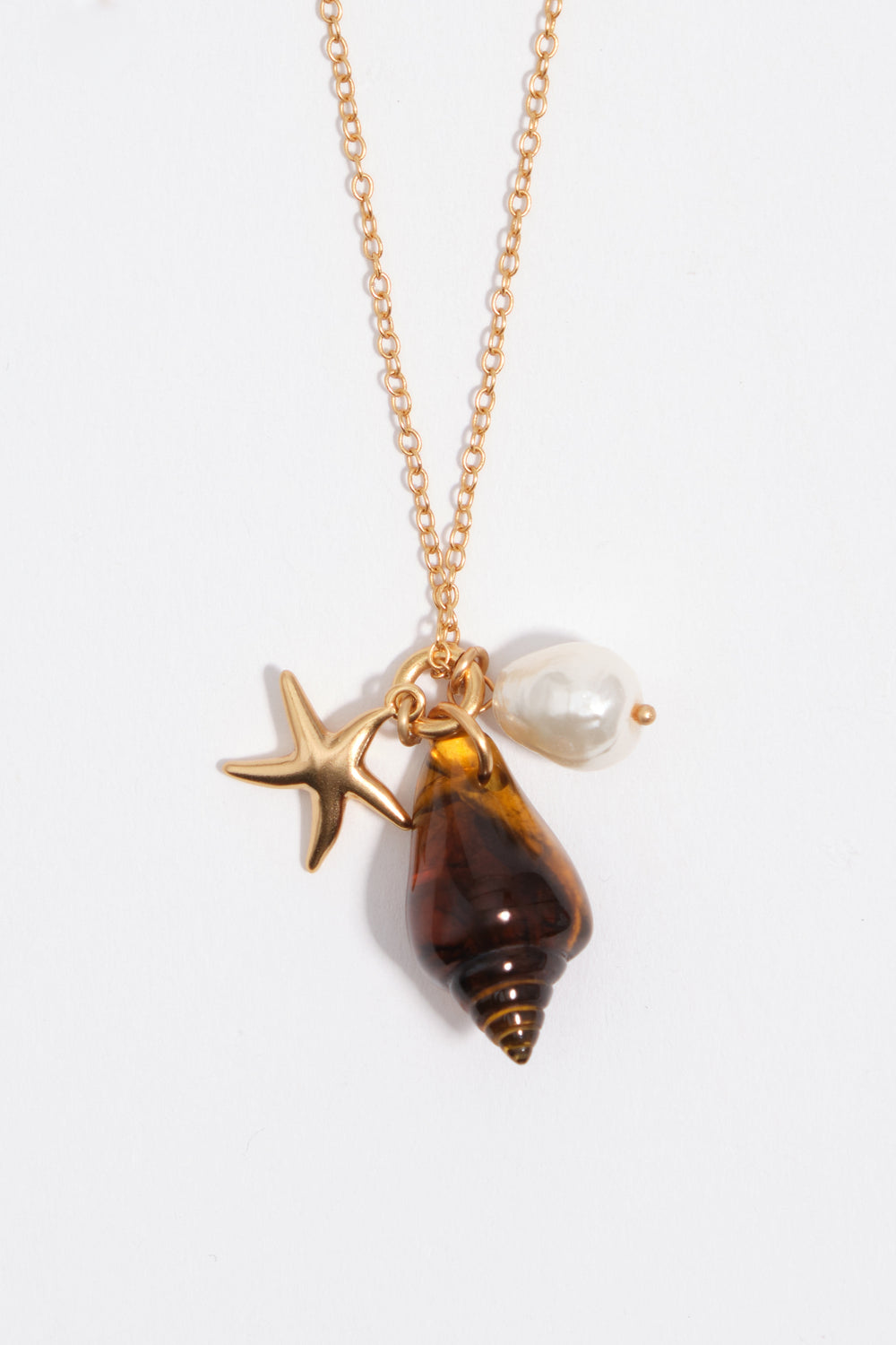 Aged gold star and shell necklace