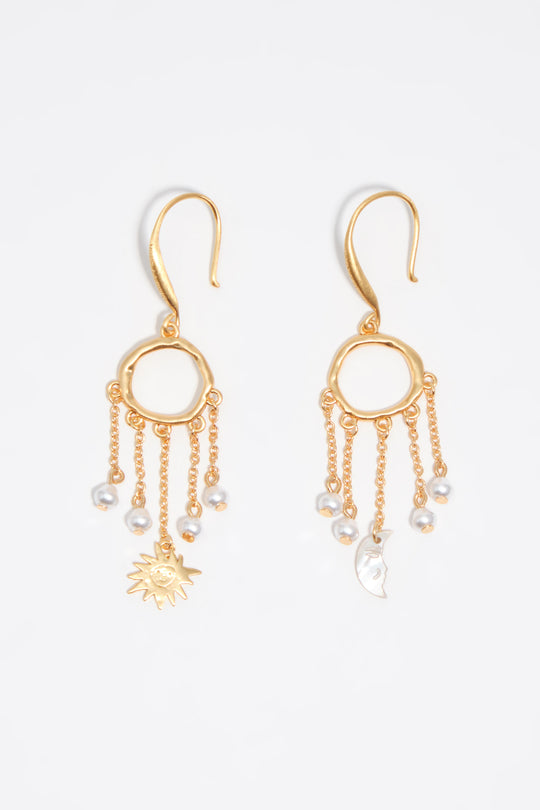 Sun and moon earrings with brushed gold chains and pearls
