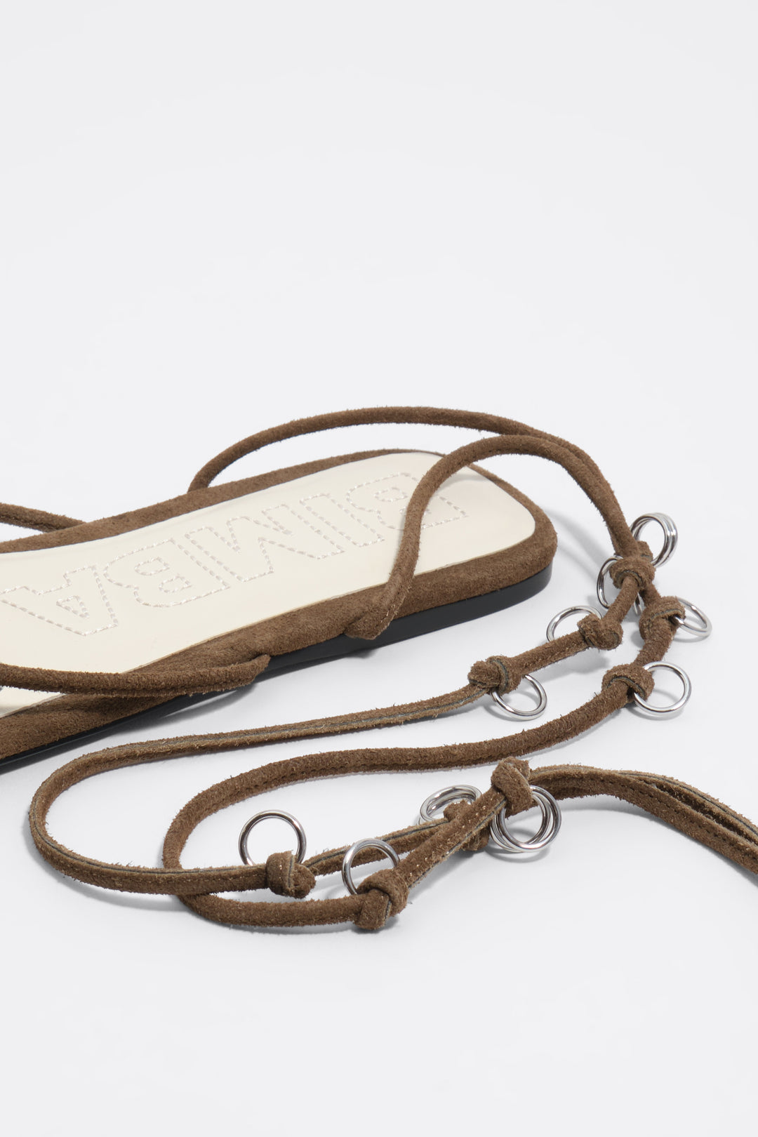 Olive suede sandal with piercings