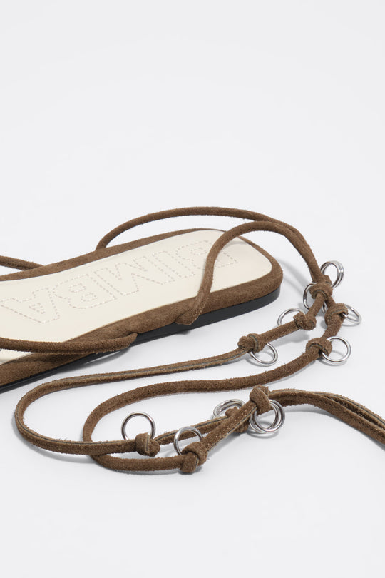 Olive suede sandal with piercings