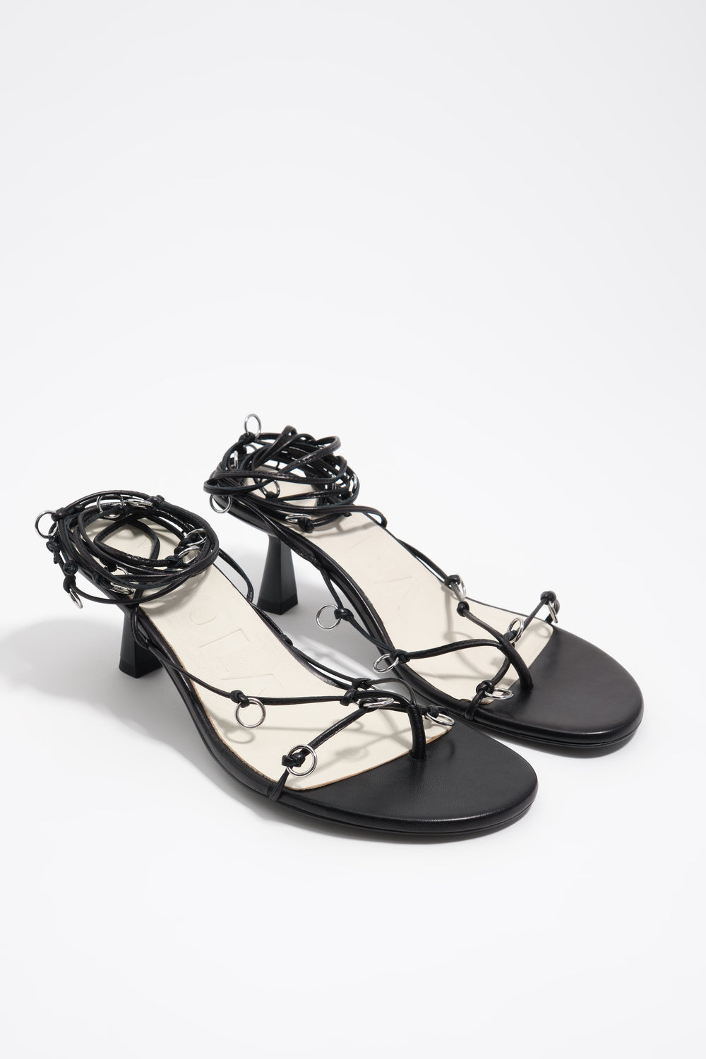 Black leather heeled sandal with piercings