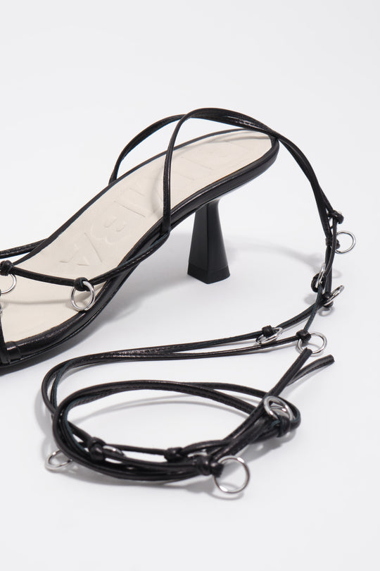 Black leather heeled sandal with piercings