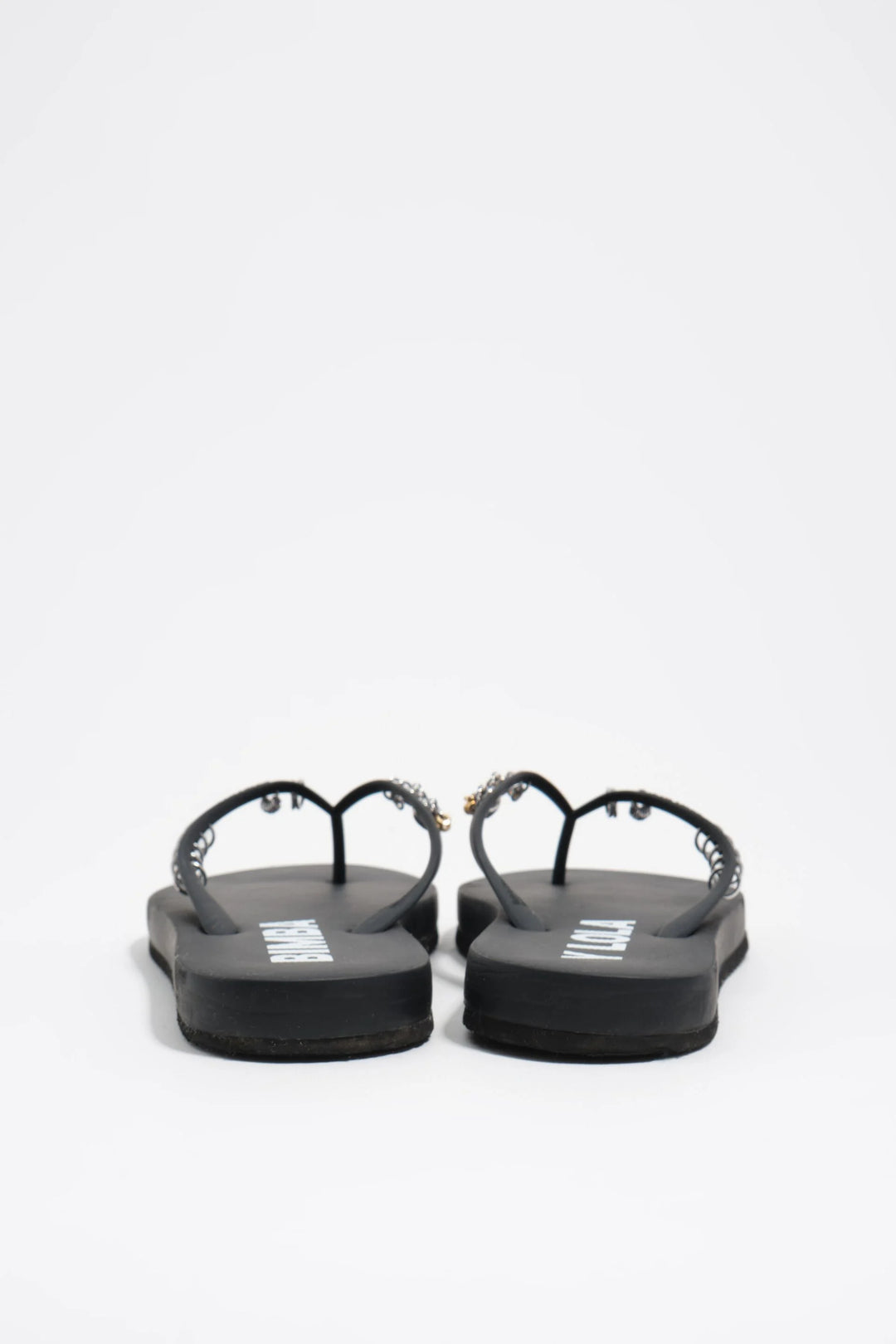 Black flip-flop with piercings