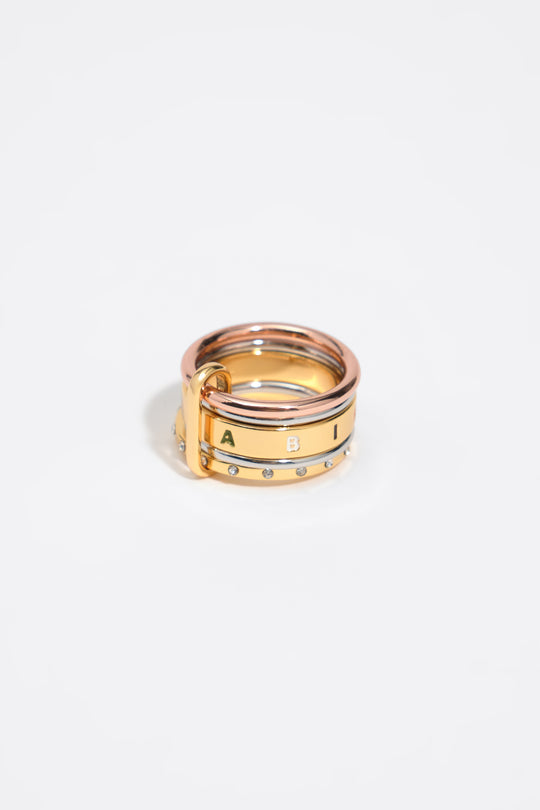 Ring with multi-gold bands and multicolored logo crystals