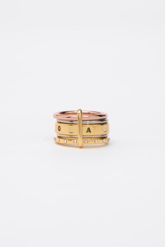 Ring with multi-gold bands and multicolored logo crystals