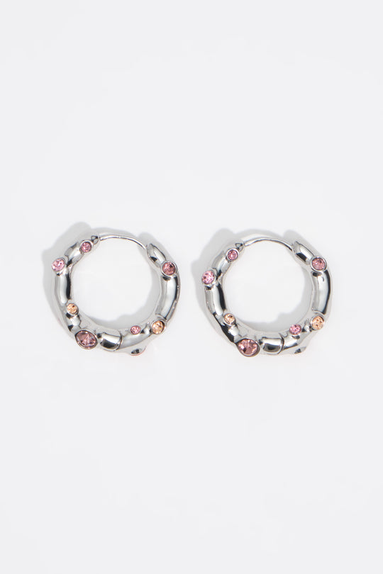 Silver textured metal hoop earrings with pink crystals