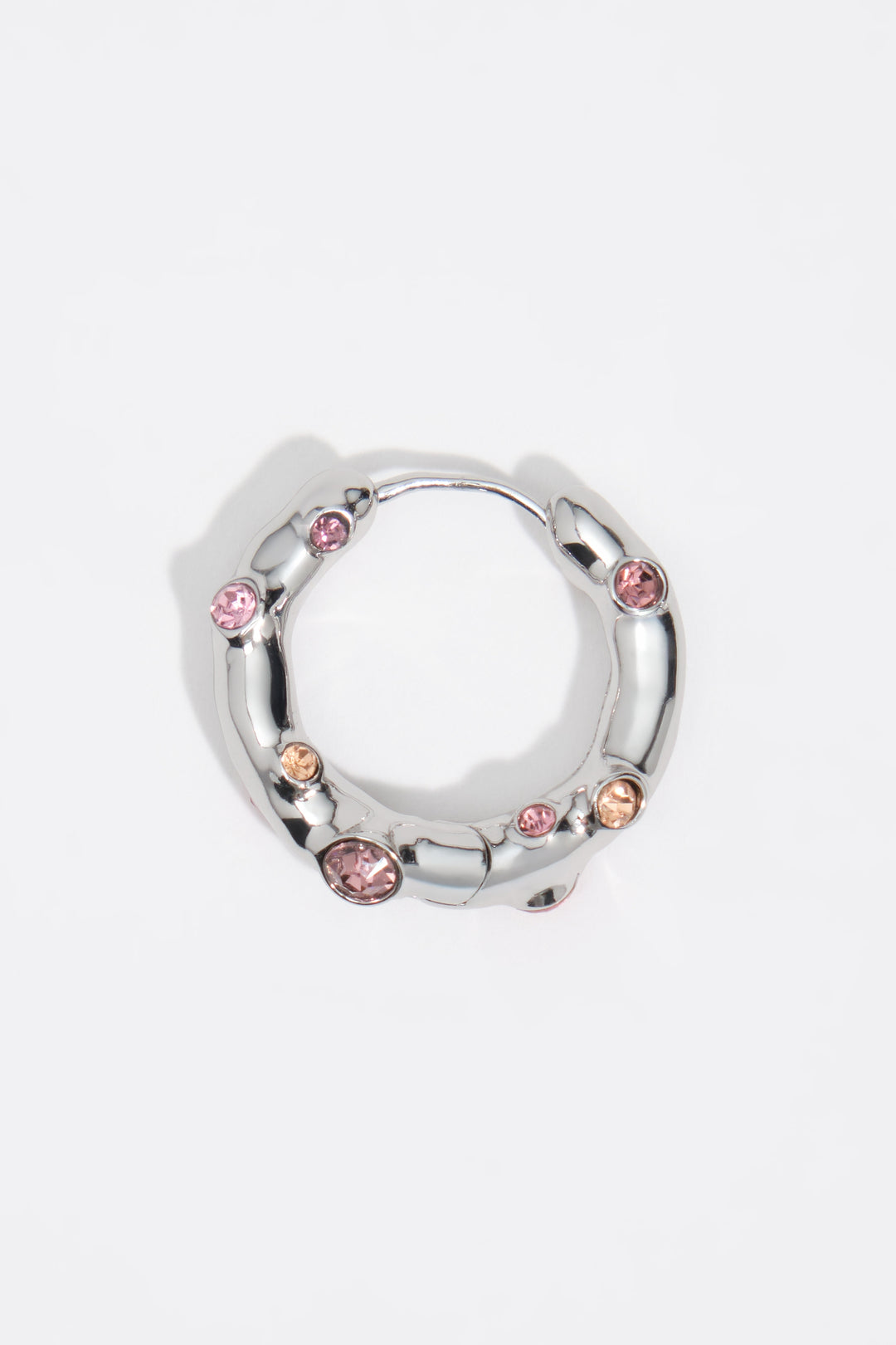 Silver textured metal hoop earrings with pink crystals