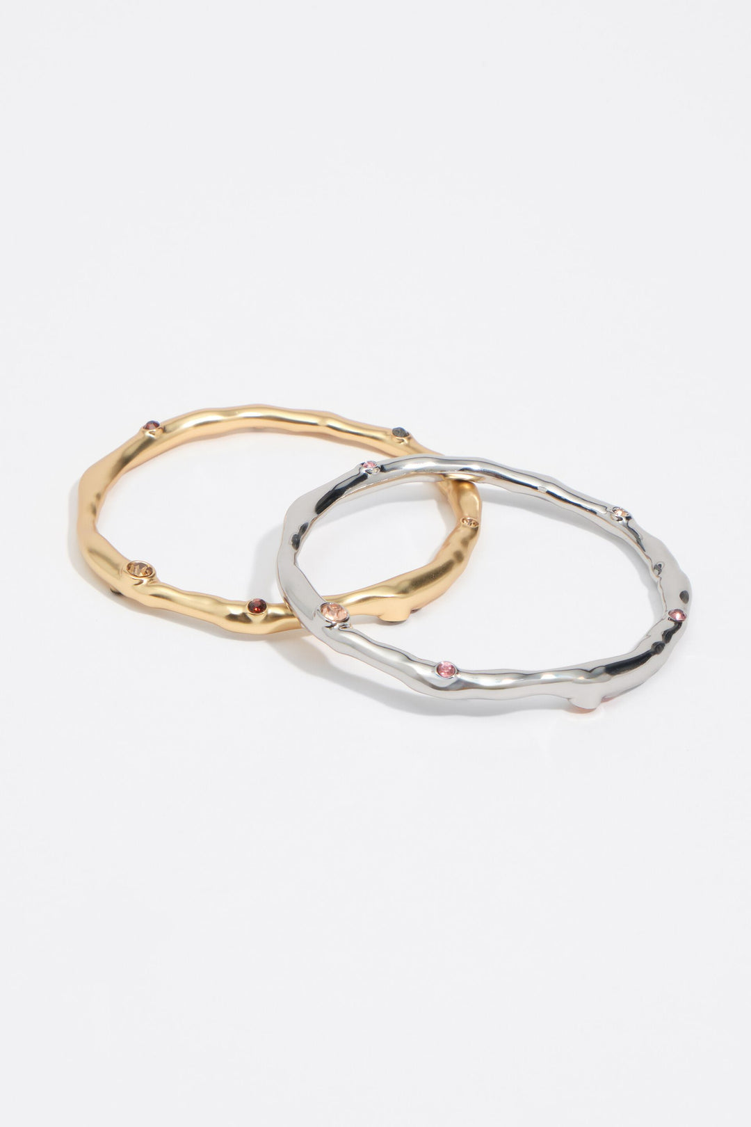 Set of 2 gold and silver textured metal bracelets with crystals