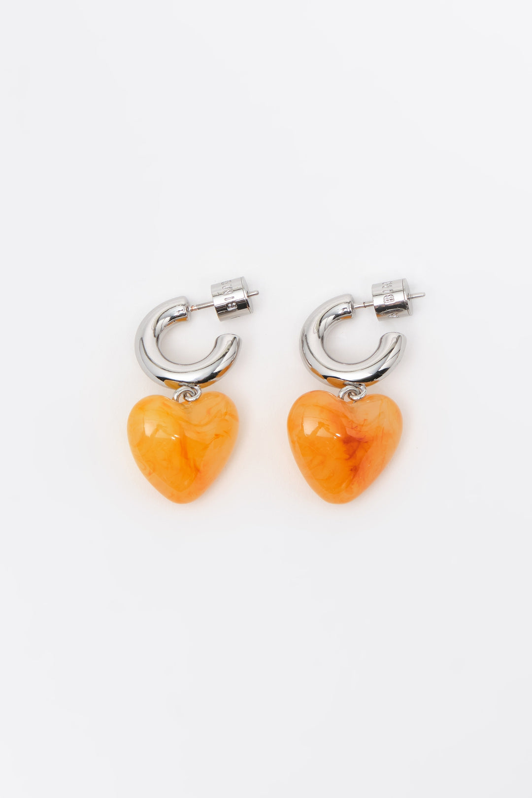 Silver hoop earrings with yellow resin heart