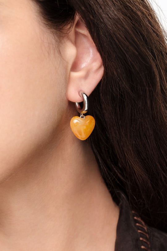 Silver hoop earrings with yellow resin heart