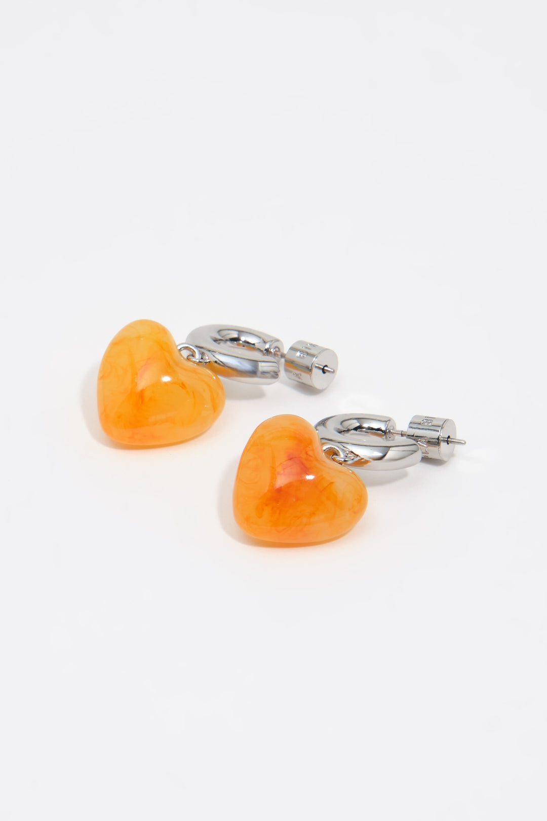 Silver hoop earrings with yellow resin heart