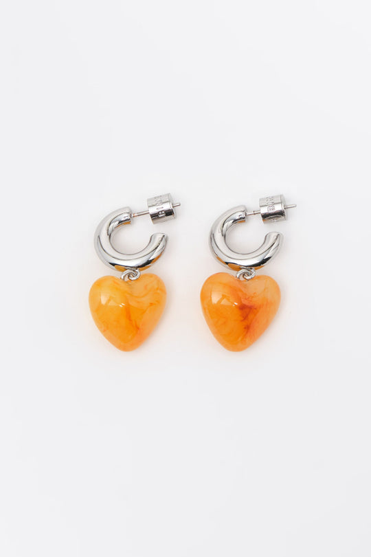 Silver hoop earrings with yellow resin heart