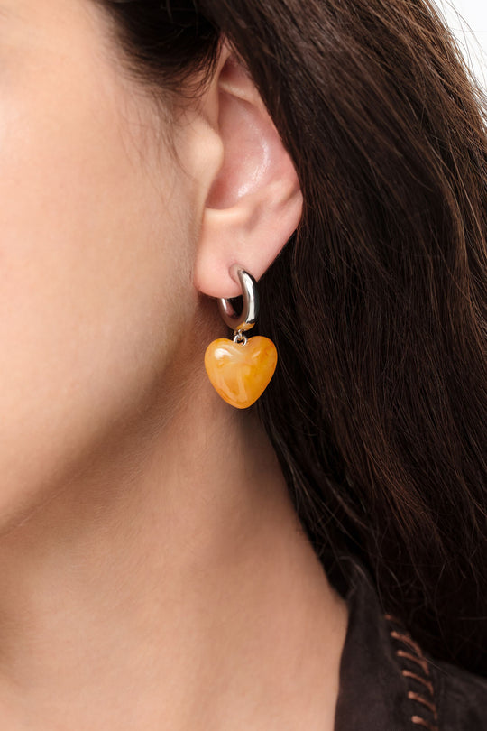 Silver hoop earrings with yellow resin heart