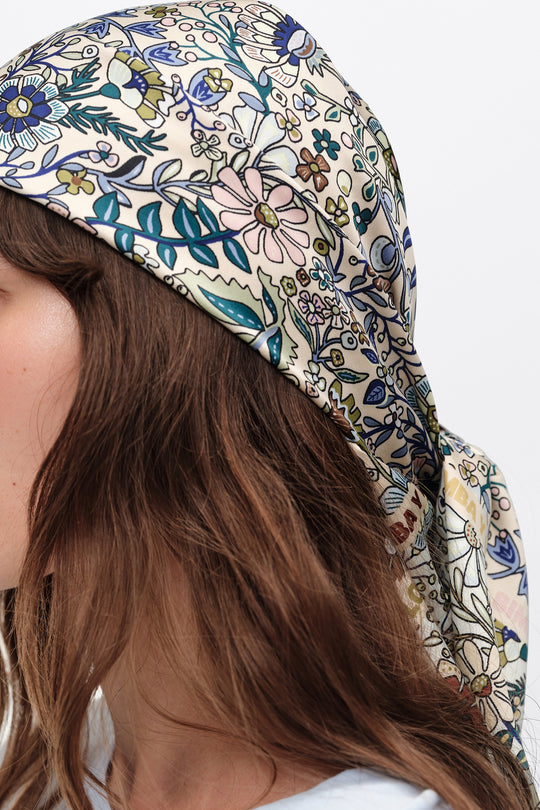 Sand-colored floral scarf with logo frame