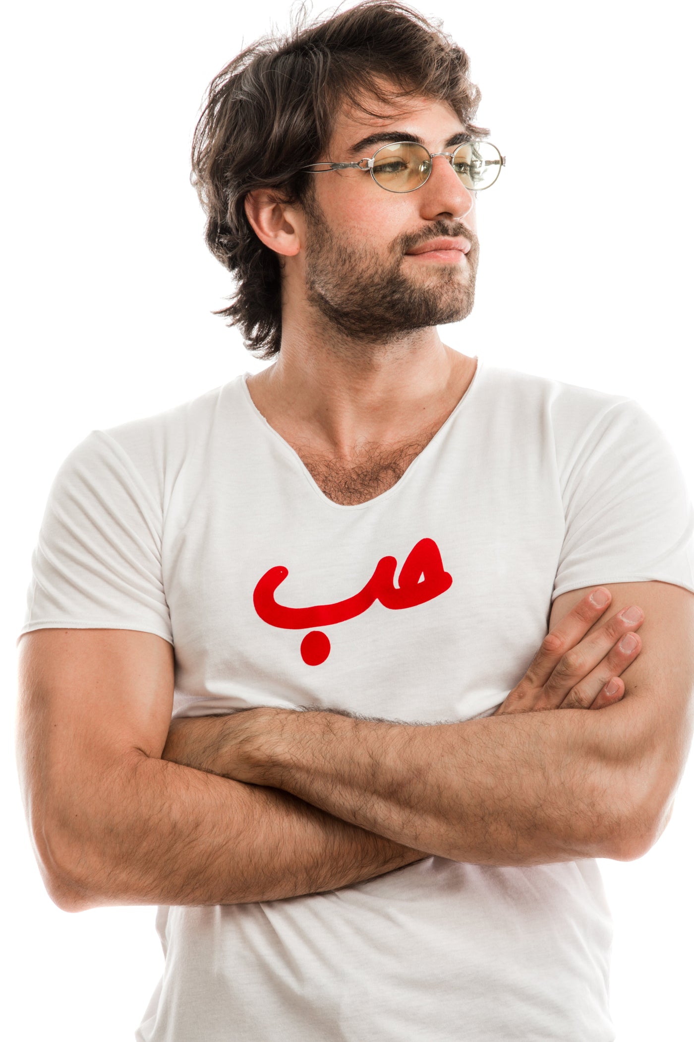 young adult male wearing white t-shirt with Hobb written in arabic حب and in red velvet in the center of the t-shirt along with glasses
