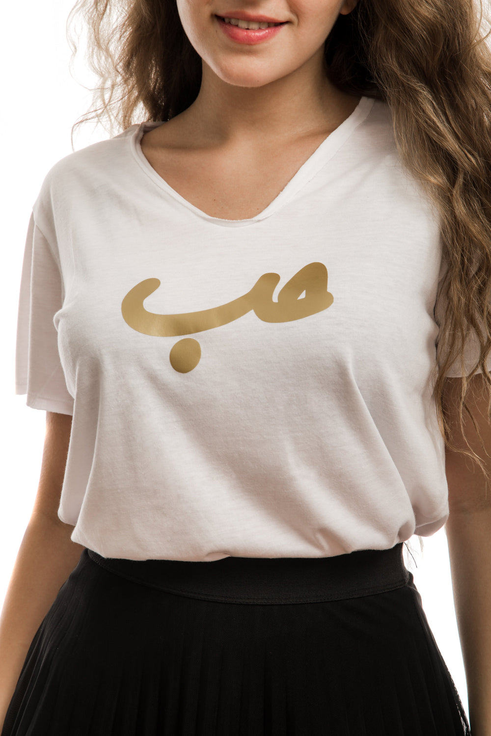 young adult female wearing white t-shirt with hobb written in arabic حب and in gold in the center of the t-shirt